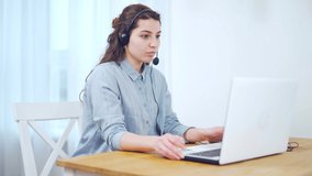 Portrait millennial female student studying online via internet while sitting at home a desk with a laptop. young woman university or college student with a headset talks remotely. Distance Learning
