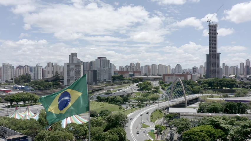 entrance to Tatuapé neighborhood, Brazilian flag fluttering in the foreground, São Paulo, Brazil