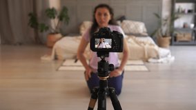 Female blogger is recording video with camera at home. Shelter in place during covid 19. Modern technology and vlogging concept. Video chat, videocourse, the remote communication, distance learning