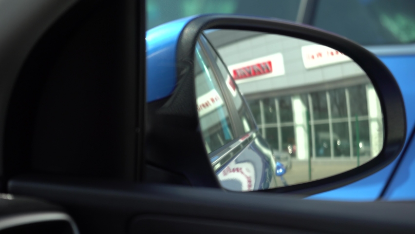 side mirror of a blue indigo sports car