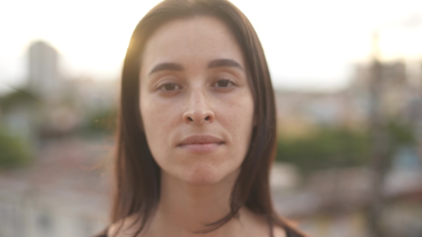 Close up view of white woman looking to camera. Portrait of serious girl standing at sunset light.Concept of people and emotions.
 Royalty-Free Stock Footage #1064973967