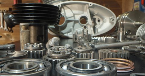 Motorcycle engine rebuild disassembled parts in garage workshop macro probe lens