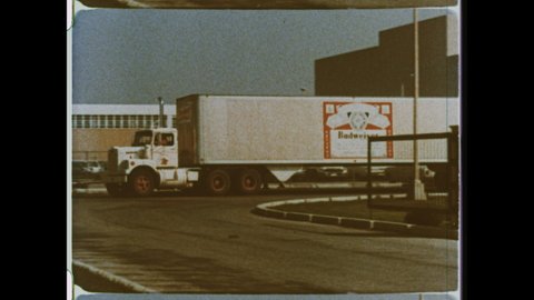 1970s St Louis, MO. A Budweiser Semi-Trailer Truck leaves the bottling plant. 4K Overscan of Archival 16mm Film Print