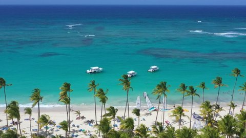 BAVARO, PUNTA CANA, DOMINICAN REPUBLIC - 10 MAY 2019: Aerial view on tropical seashore with RIU resort beach and caribbean sea with speedboats
