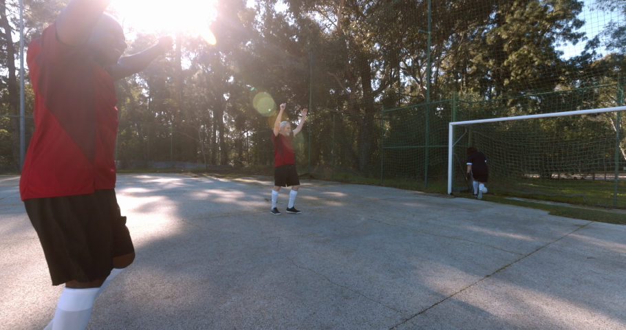 Team of seniors celebrating goal during soccer match