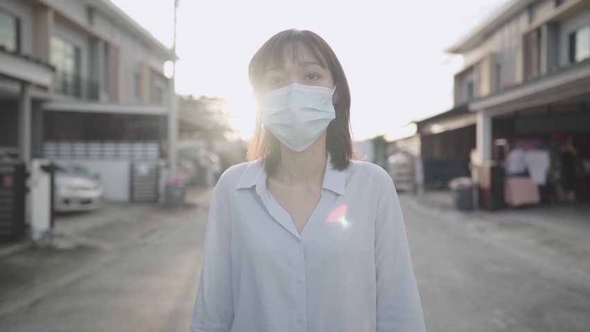 Asian woman wear protective face mask, feeling confident walk out the house neighborhood, new normal lifestyle covid-19 pandemic, infectious diseases protection, risk prevention, air pollution problem | Shutterstock HD Video #1064995087