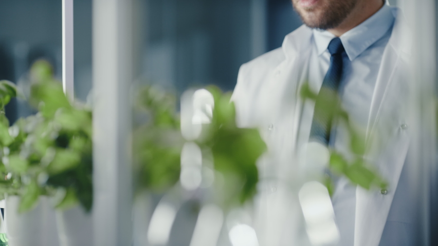 Handsome Male Microbiologist Looking at a Lab-Grown Cultured Vegan Meat Sample. Medical Scientist Working on Plant-Based Beef Substitute for Vegetarians in a Modern Food Science Laboratory. Royalty-Free Stock Footage #1064997856