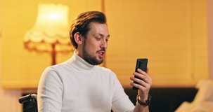Young business man communicating by video call. Bearded businessman speaking looking at phone screen, online conference distance office chat, virtual training concept.