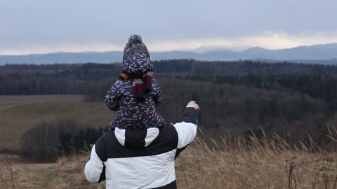 father and son on a winter walk in the Sudetes, Poland