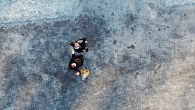 Couple getting outdoors together in a winter day in europe city. Aerial video