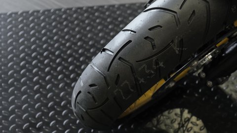 The rubber tread of a new sports bike in the dealer showroom.
