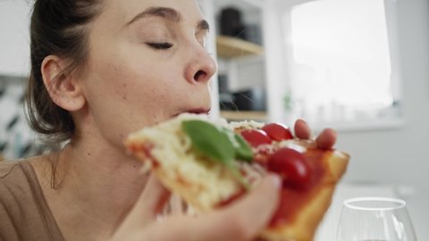 Tracking video of women eating a handmade pizza. Shot with RED helium camera in 8K