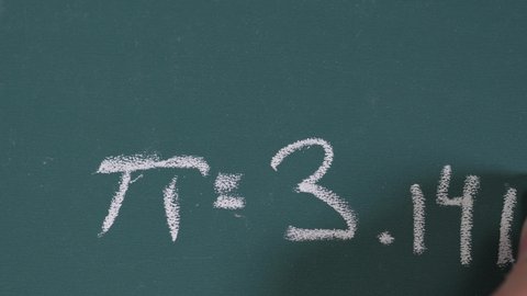On a chalk board writing the number of Pi with a chalk. closeup shot
