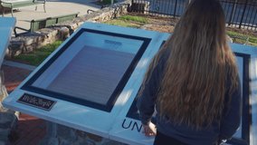 Teen girl looking at the United States Constitution on display . High quality 4k footage - Powered by Shutterstock - Get 15% off with code: PIKWIZARD15