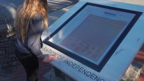 Teen girl looking at the United States Constitution on display . High quality 4k footage - Powered by Shutterstock - Get 15% off with code: PIKWIZARD15