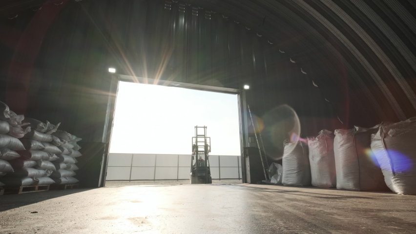 Warehousing. Forklift driver stacking big bag of raw material in warehouse., an Industrial Video by Eugene Gorun