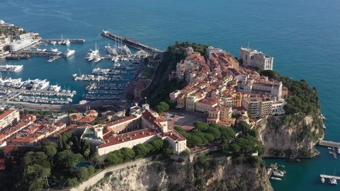 France, Prince's Palace of Monaco, Grimaldi family. Drone aerial view above the Royal Palace perched on the rock facing the harbor and the blue sea.