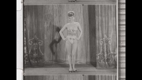 1950s Los Angeles. Woman in Bikini on Stage Poses for Beauty Pageant. 4K Overscan of Vintage Archival 16mm film Print