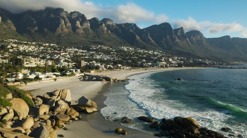 Aerial fly over view of a deserted Camps Bay beach, Lockdown Covid-19 Pandemic, Cape Town, South Africa