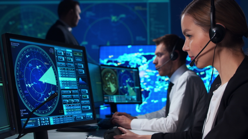 Workplace of the air traffic controllers in the control tower. Team of aircraft control officers works using radar, computer navigation and digital maps. Aviation concept. Royalty-Free Stock Footage #1065064828