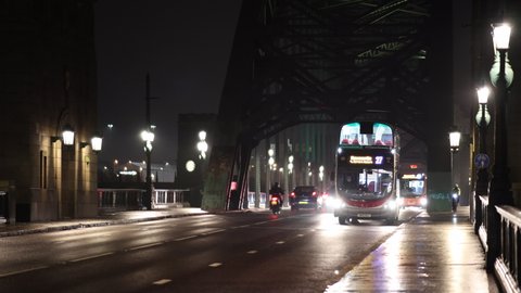 Newcastle upon Tyne UK: 11th Dec 2020: Cyclist on Tyne Bridge in Newcastle at night 