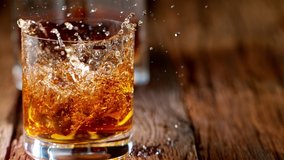 Pouring whiskey on vintage wooden table in super slow motion. Shot with high speed cinema camera, 1000fps. - Powered by Shutterstock - Get 15% off with code: PIKWIZARD15