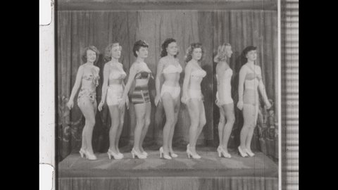 1950s Los Angeles, CA. Beauty Contestants on Stage, twirl in a circle to Display their Swimsuits and Bikinis. 4K Overscan of Vintage Archival 16mm film Print