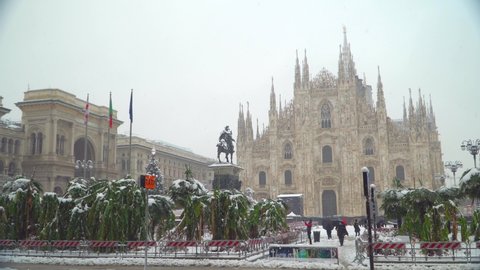 Christmas tree in the central square of the Duomo in front of the cathedral in Milan, Italy December 2020. Christmas holidays. Snow covered palms. New Year 2021. Snowfall in Milan. Winter city