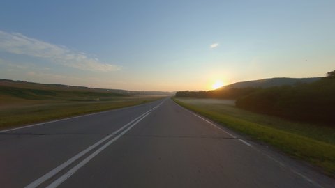 Driving Down Empty Road, During summer In Bashkortostan. Beautiful view at dawn from the car