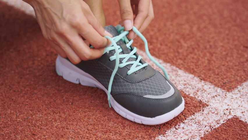 Close up Women runners lace up their shoes getting ready to exercise.
