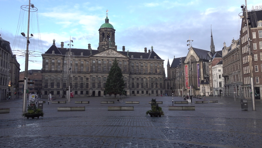 AMSTERDAM, NETHERLANDS – 1 JANUARY 2021: Christmas tree on almost empty Dam Square in central Amsterdam, as Europe battles second wave of Covid-19 coronavirus pandemic. Winter lockdown.