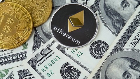 Bitcoin BTC and Ethereum ETH coins on 100 dollar bills, different cryptocurrency. New modern payments. Record high boosted by increased demand from both institutional and retail investors 