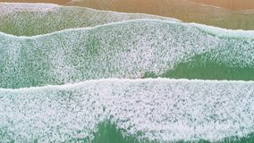 Cinematic aerial view summer beach and sea video.Top view of sea foam splashing waves summer season day 4K 59.94 FPS. drone view background footage for commercial,Top down sea White sea foamy wave