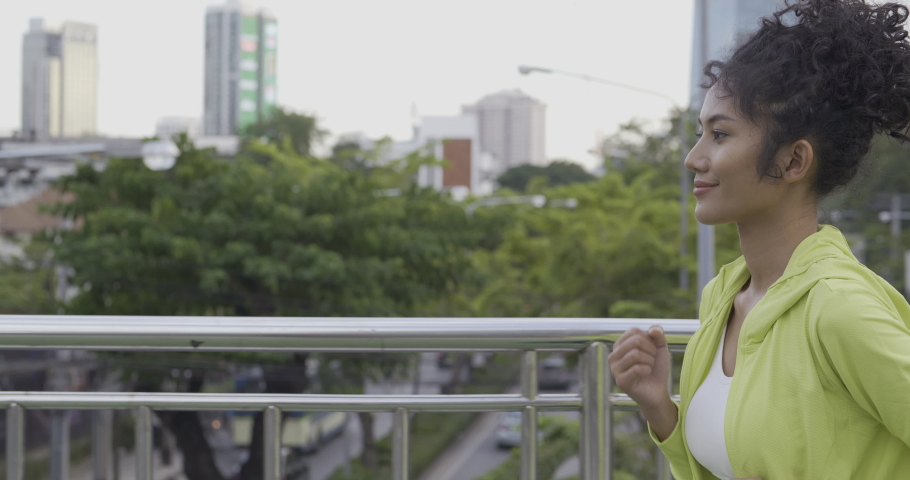 Slow motion shot, Beautiful sport girl running at city. Sport woman concentration with running at outdoor place.