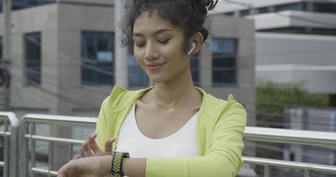 Sport girl using smartwatch when she exercise with smiling. Healthcare, Sport and Technology concept.