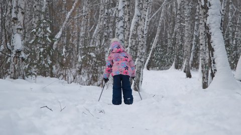 Little Girl Enjoying Cross Country Skiing in Winter Forest. Winter Sport Activities and Healthy Lifestyle Concept