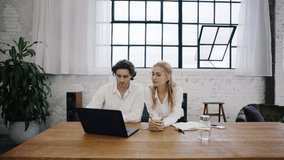 Young attractive woman and man sit in the office and work together from home. Remote work, Home office, Office, Startup