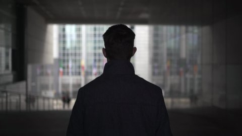 Man walking in the European Parliament area in Brussels. Following silhouette of Politician, Lobbyist or Businessman in the tunnels of the EU government building