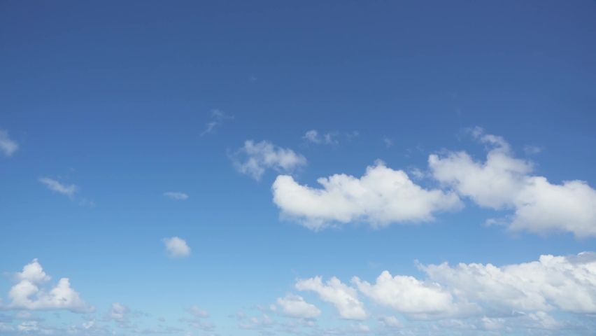 Beautiful white clouds dissolve into the blue sky. Summer cloudscape time lapse. Sunny cloudy background. Royalty-Free Stock Footage #1065139417