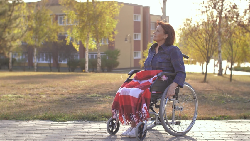 Woman sit on wheelchair at the park