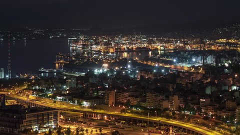 Establishing Aerial View Shot of Athens, commercial part of Port of Piraeus, Greece at night evening