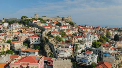 Aerial drone view above Greek town Kavala. Flying top view of old town and sea port of famous UNESCO world heritage historic monument from medieval roman empire ages.