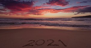 2021 new year morning on the beach, dramatic colorful cloudscape and sea sunrise