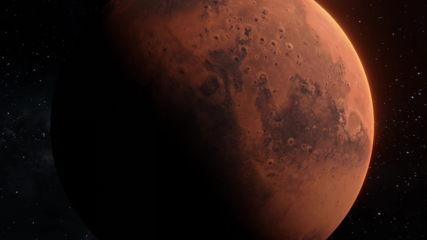 Mars planet spinning in open space over stars background. Zoom out front view of Mars red planet in 4k footage. 3d planet half illuminated with the Sun