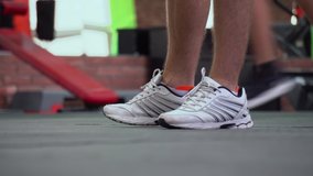 A training session with the trainer at the gym. Man's legs. Running in a circle. Warm up before the training session  - Powered by Shutterstock - Get 15% off with code: PIKWIZARD15