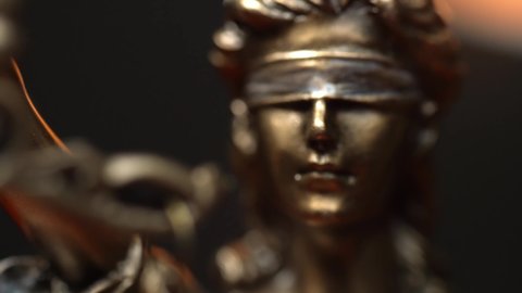 The Statue of Justice - lady justice, Roman goddess of Justice in lawyer office. close up tracking shot