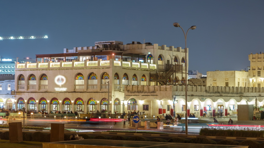Souq Waqif night timelapse. It is popular marketplace in Doha, Qatar. The souq is noted for selling traditional garments, spices, handicrafts, and souvenirs. view from park