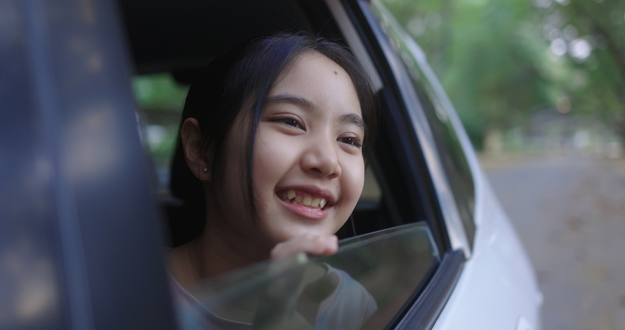 Cinematic Pretty Asian Girl In Car, Leans Out Passenger Side Car Window. Opens Window To Breathe Fresh Air Of Countryside. | Shutterstock HD Video #1065186859