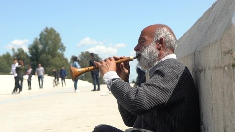 Adana, Turkey - May 15, 2018: Street musician playing the zurna music instrument.
