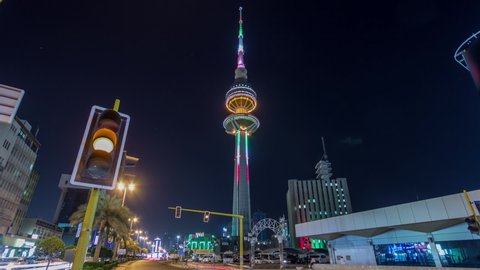 KUWAIT - CIRCA FEB 2019: The Liberation Tower timelapse hyperlapse in Kuwait City illuminated at night with traffic on the road. Kuwait, Middle East
